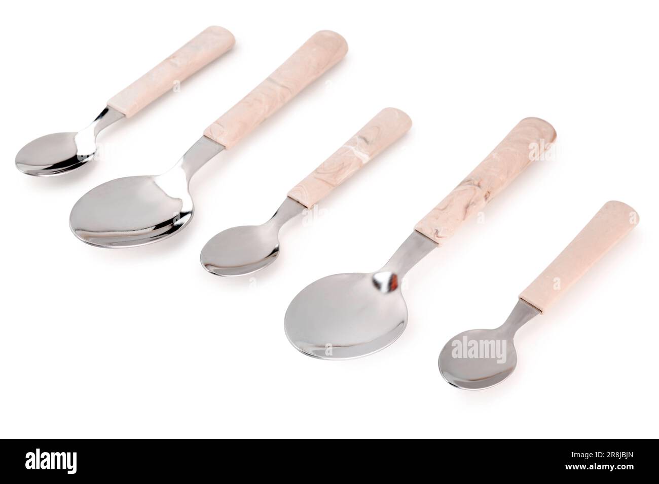 Stainless steel spoons with plastic handles on white background Stock