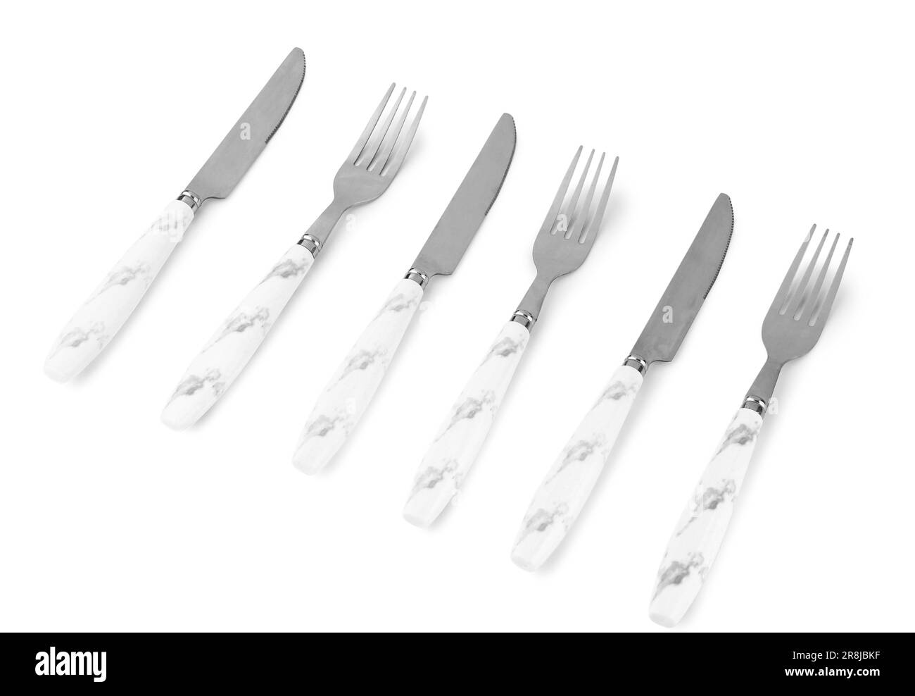 Stainless steel forks and knives with plastic handles on white background Stock Photo