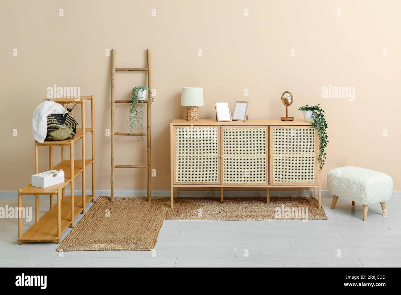 Stylish interior of living room with shelving unit, ladder, drawers and ...