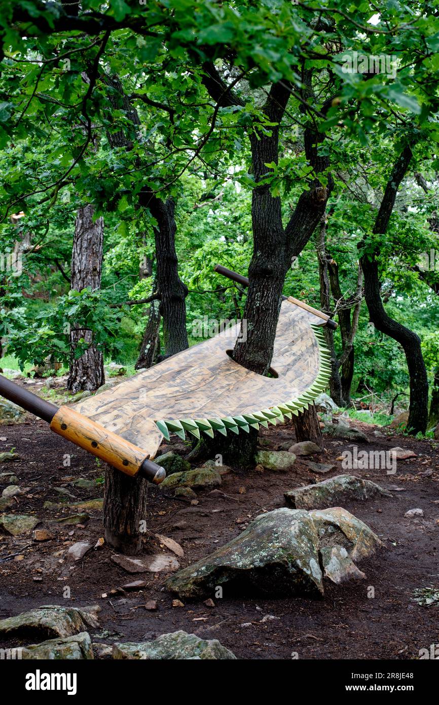 forest decoration, wood saw protects a tree from being cut down Stock Photo