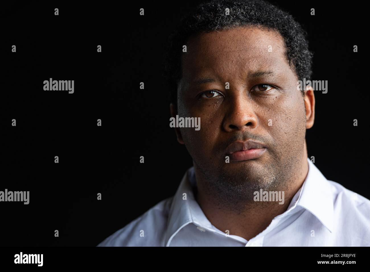 Portrait of handsome African man against black background Stock Photo