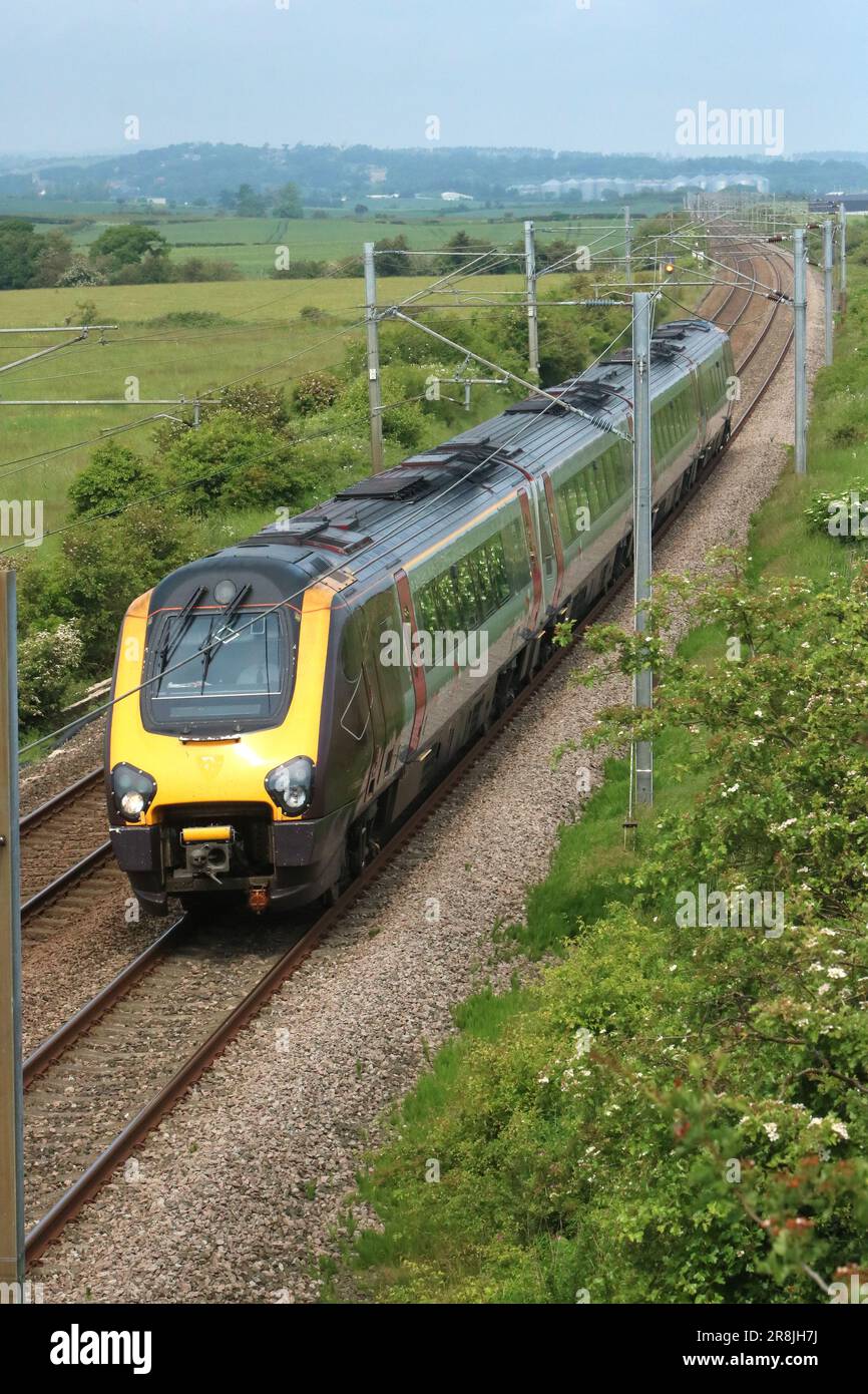 CrossCountry voyager diesel multiple unit train in countryside on East Coast Main Line railway near Belford in Northumberland on 12th June 2023. Stock Photo