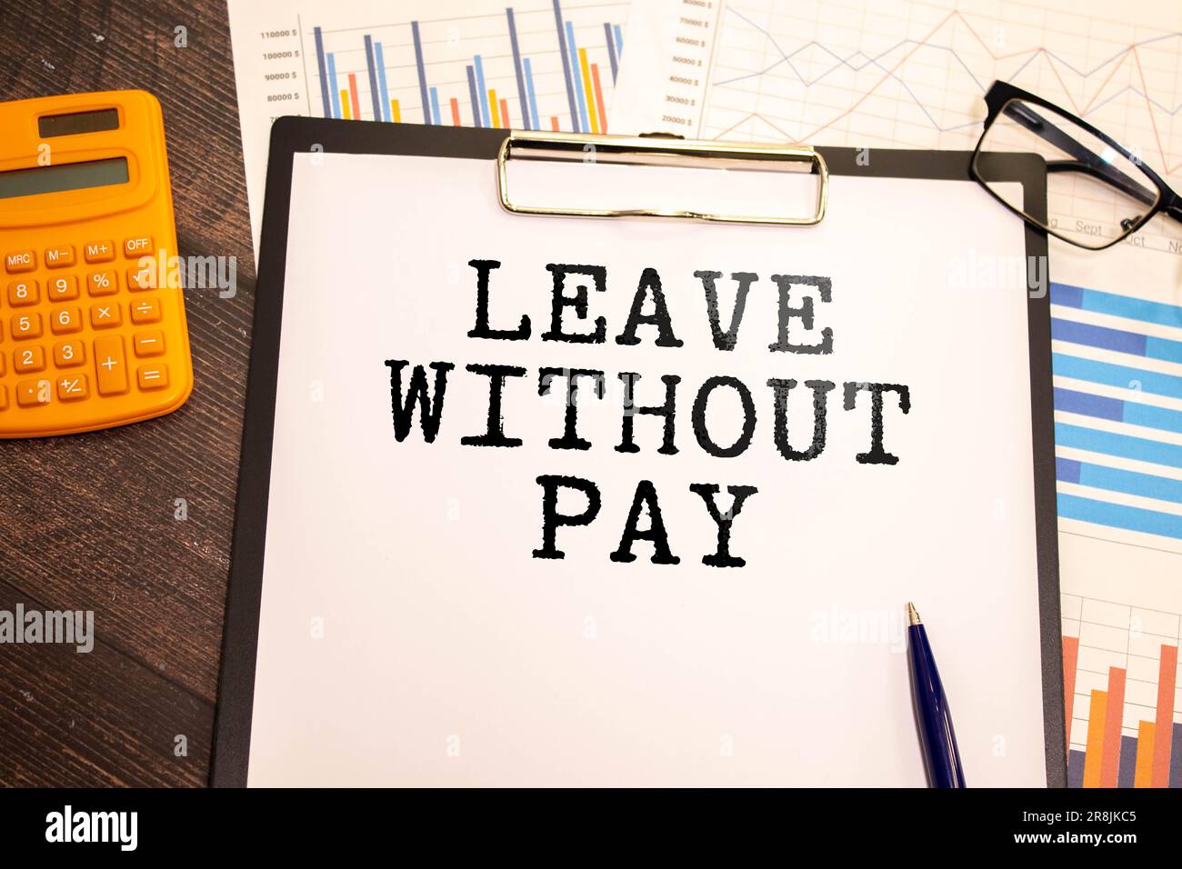 Closeup on businessman holding a card with text LEAVE WITHOUT PAY
