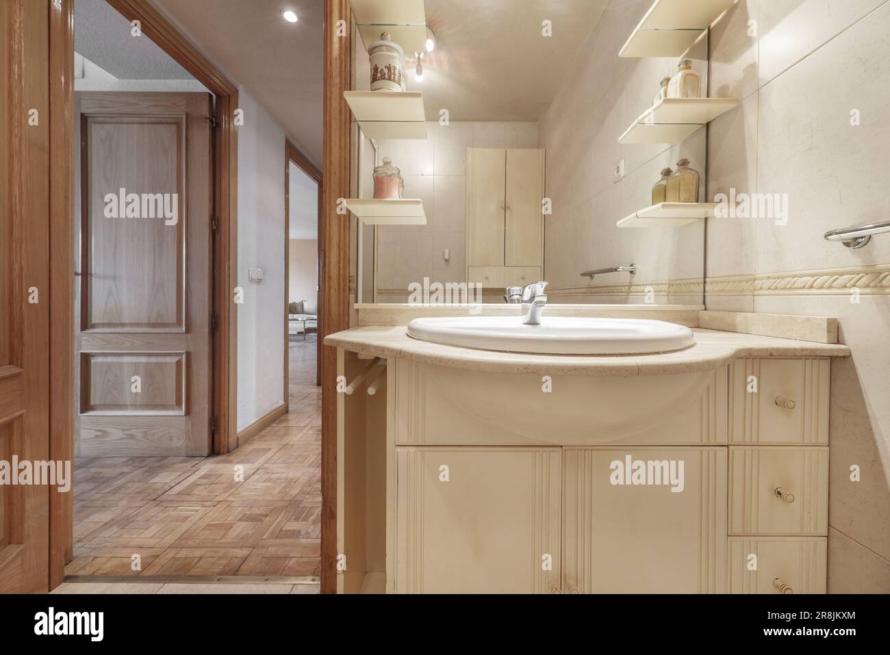 Small bathroom with a white porcelain sink embedded in a marble