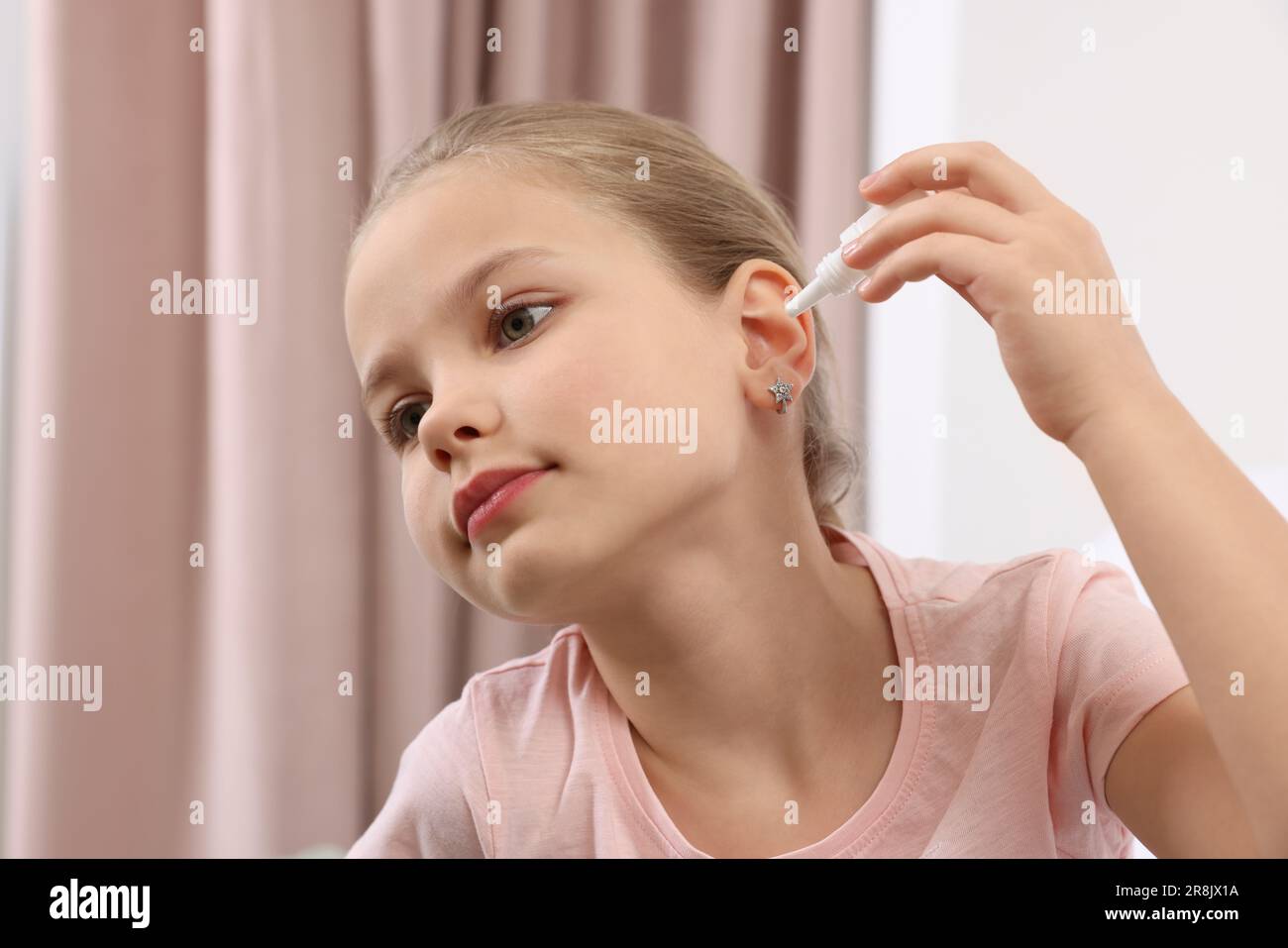 Little girl using ear drops at home Stock Photo Alamy