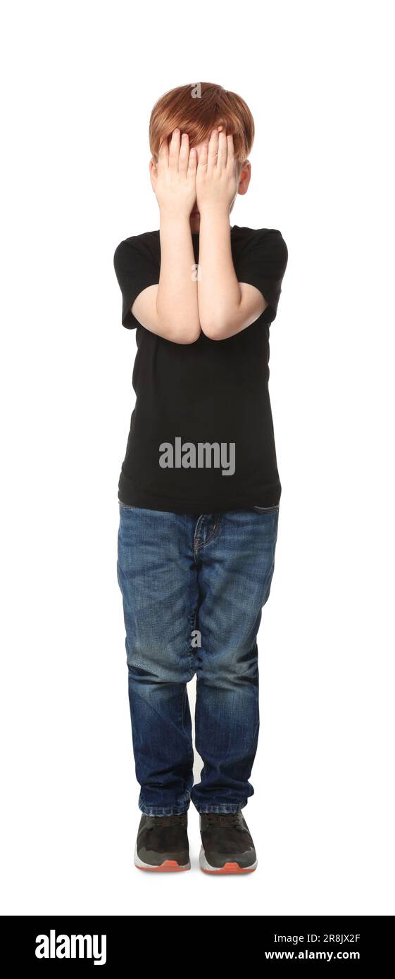 Boy covering face with hands on white background. Children's bullying Stock Photo