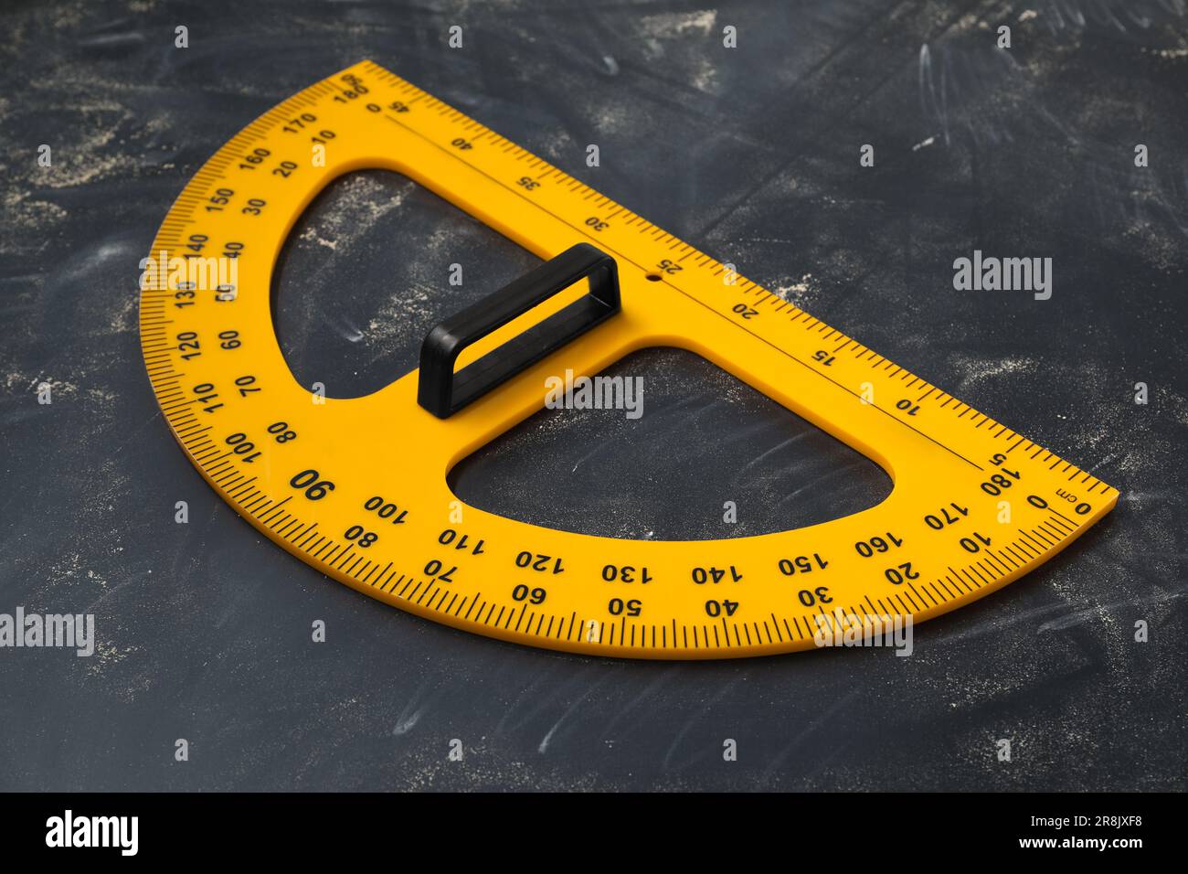 Protractor with measuring length and degree markings on blackboard