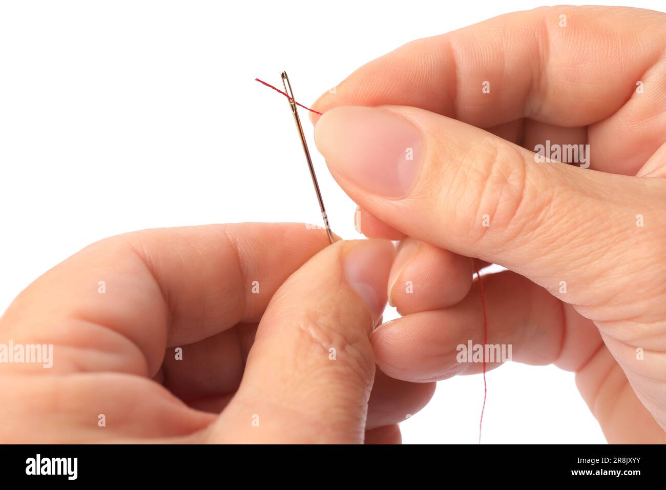 Woman threading sewing needle on white background, closeup Stock Photo