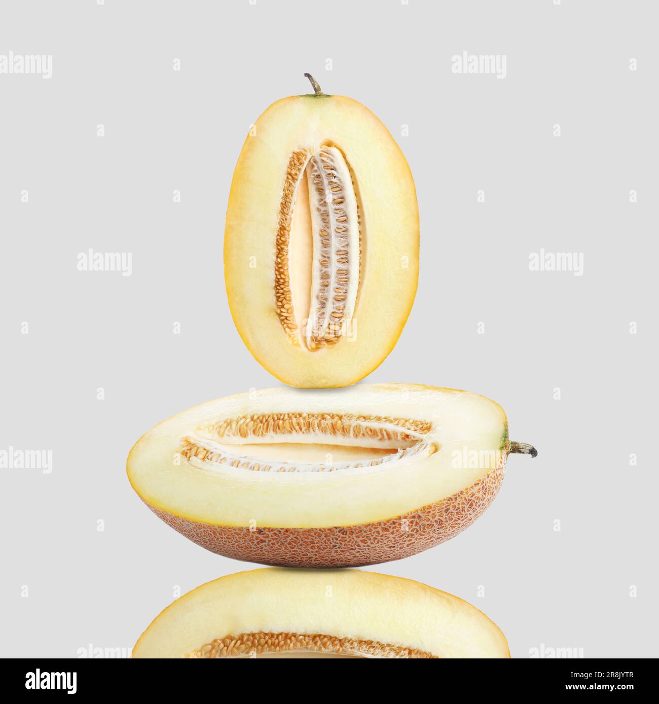Stack of fresh cut melons on light grey background Stock Photo - Alamy