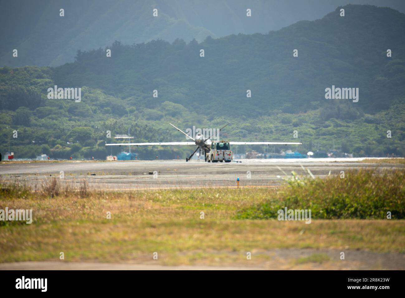 U.S. Marine Corps Marine Unmanned Aerial Vehicle Squadron (VMU) 3, Marine Aircraft Group 24, maneuvers an MQ-9A down the flight line on Marine Corps Air Station Kaneohe Bay, June 20, 2023. The MQ-9A is a remotely piloted aircraft capable of supporting a wide range of operations such as coastal and border surveillance, weapons tracking, embargo enforcement, humanitarian and disaster assistance, support of peacekeeping and counter-narcotic operations. VMU-3 supports the Marine Air-Ground Task Force by providing multi-surveillance and reconnaissance, data gateway and relay capabilities through an Stock Photo