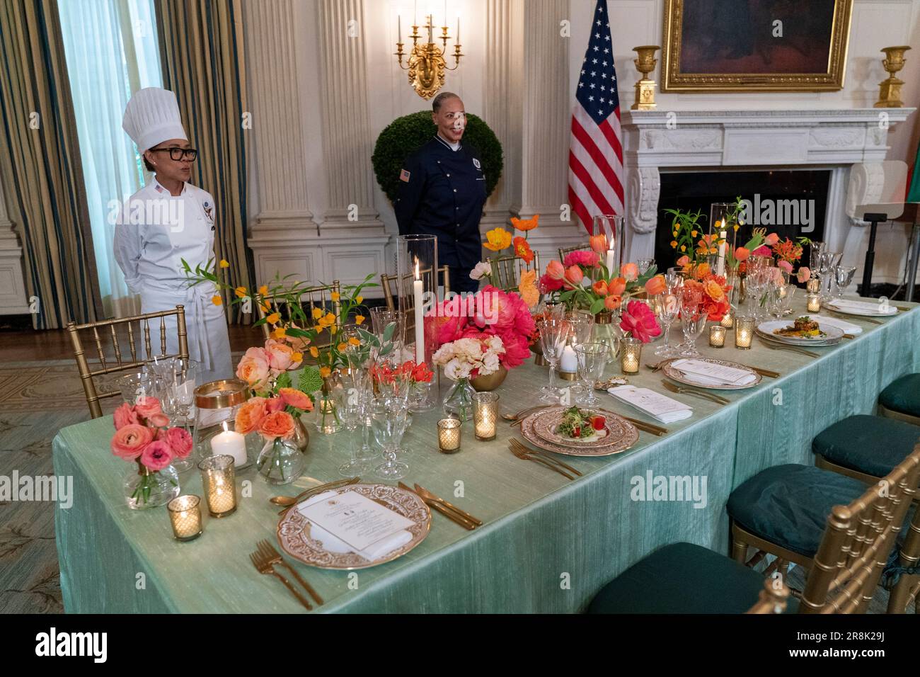 White House executive chef Cristeta Comerford, left, and guest chef Nina Curtis, stand behind