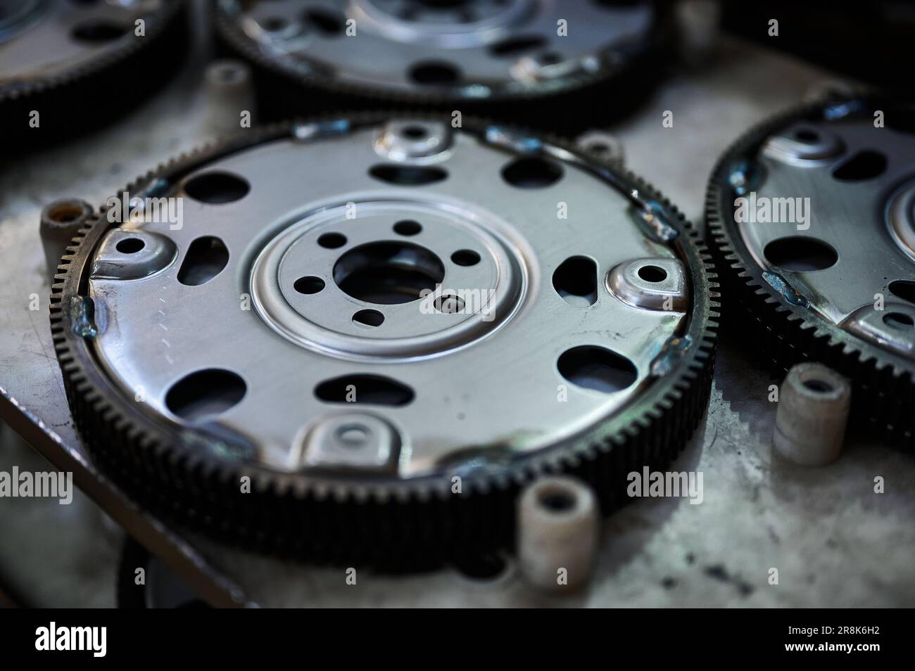 Car engine flywheels on shelf at auto production factory Stock Photo