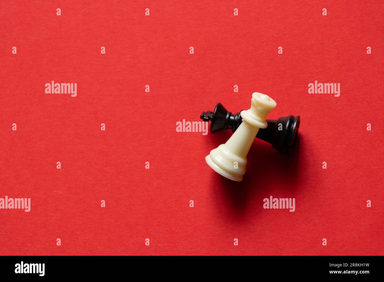 two chess pieces black and white on a red background close up Stock ...