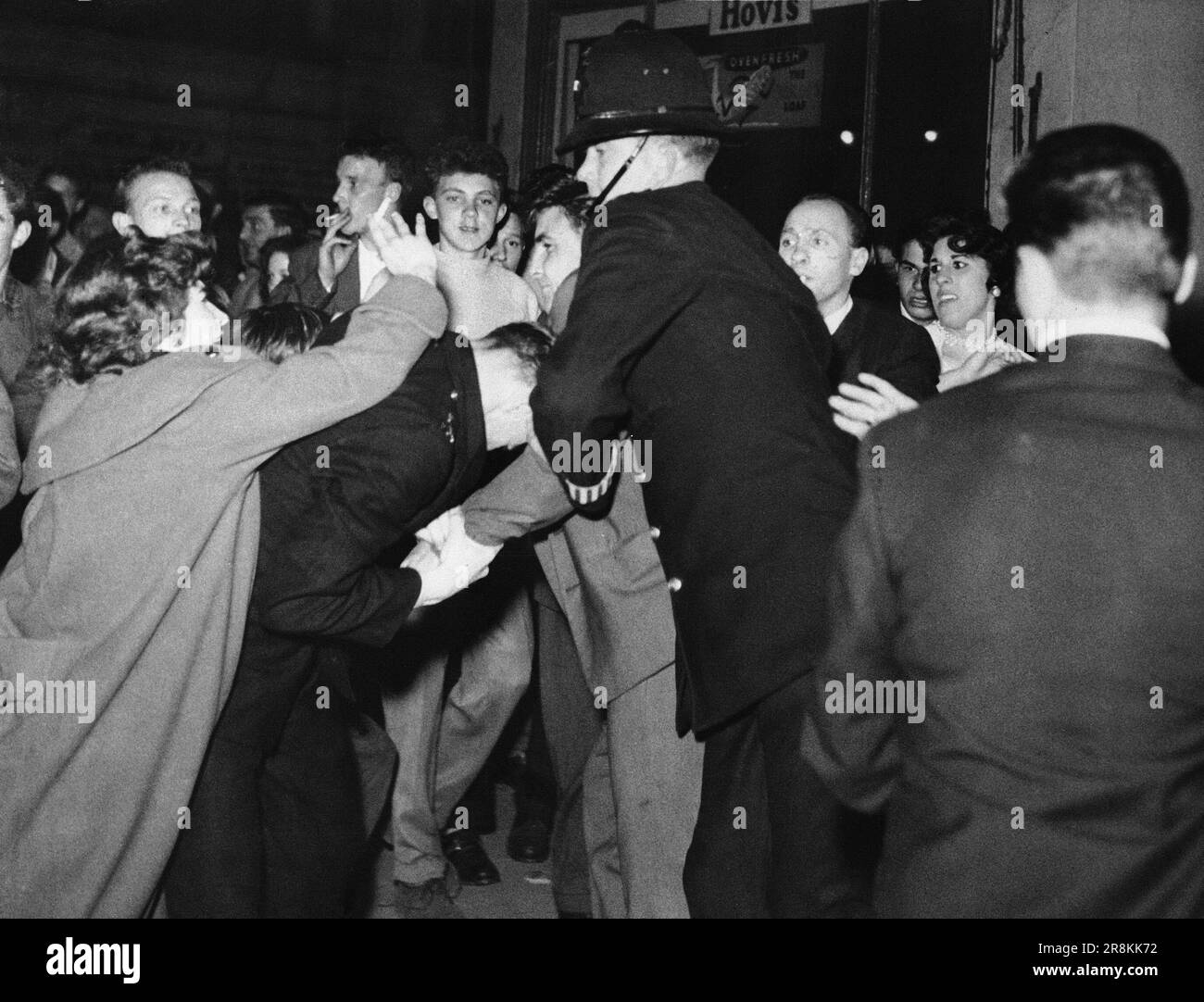FILE - A British policeman center, comes to the aid of a fellow police ...