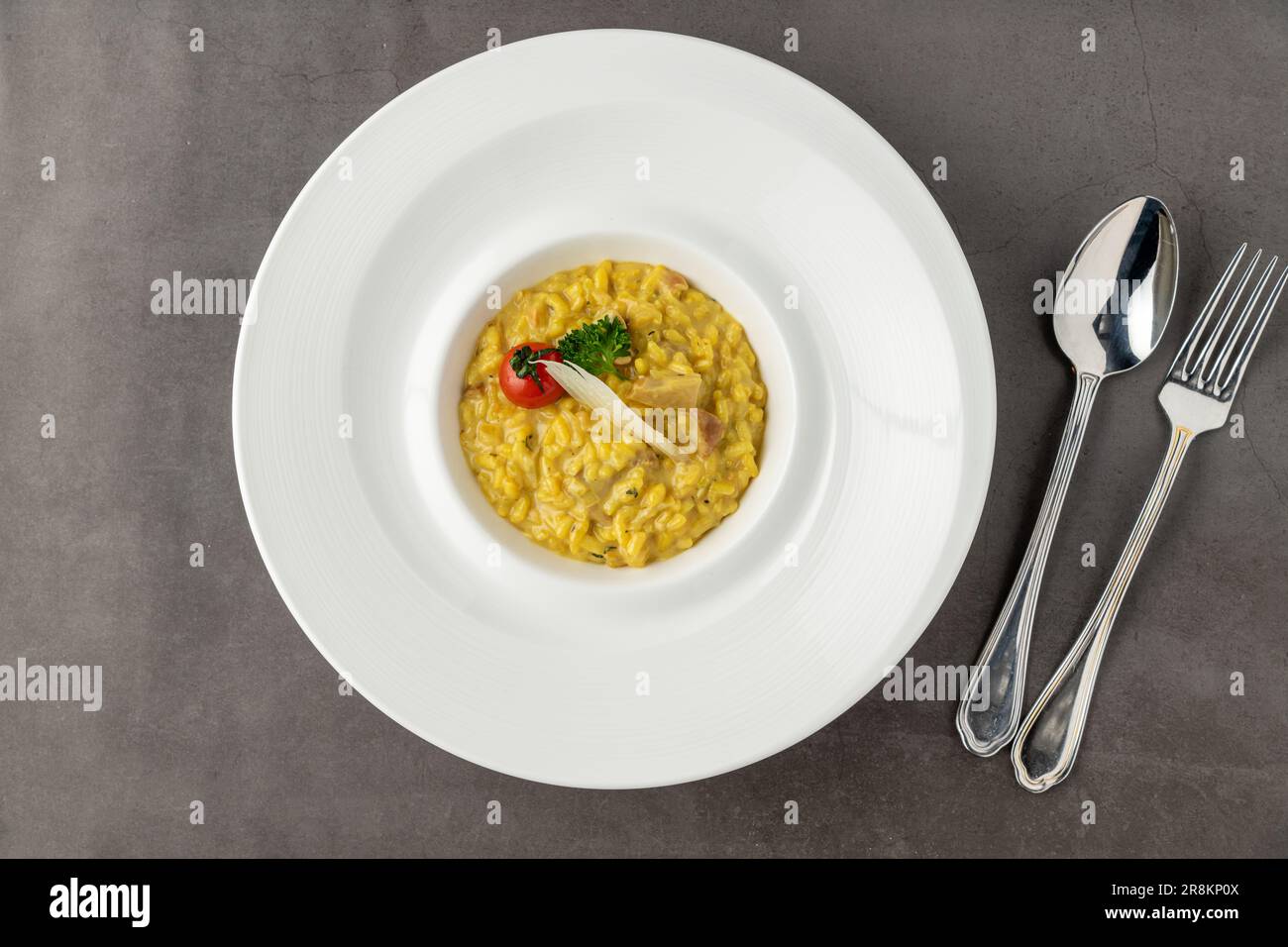 Parmesan cheese risotto on a white porcelain plate Stock Photo