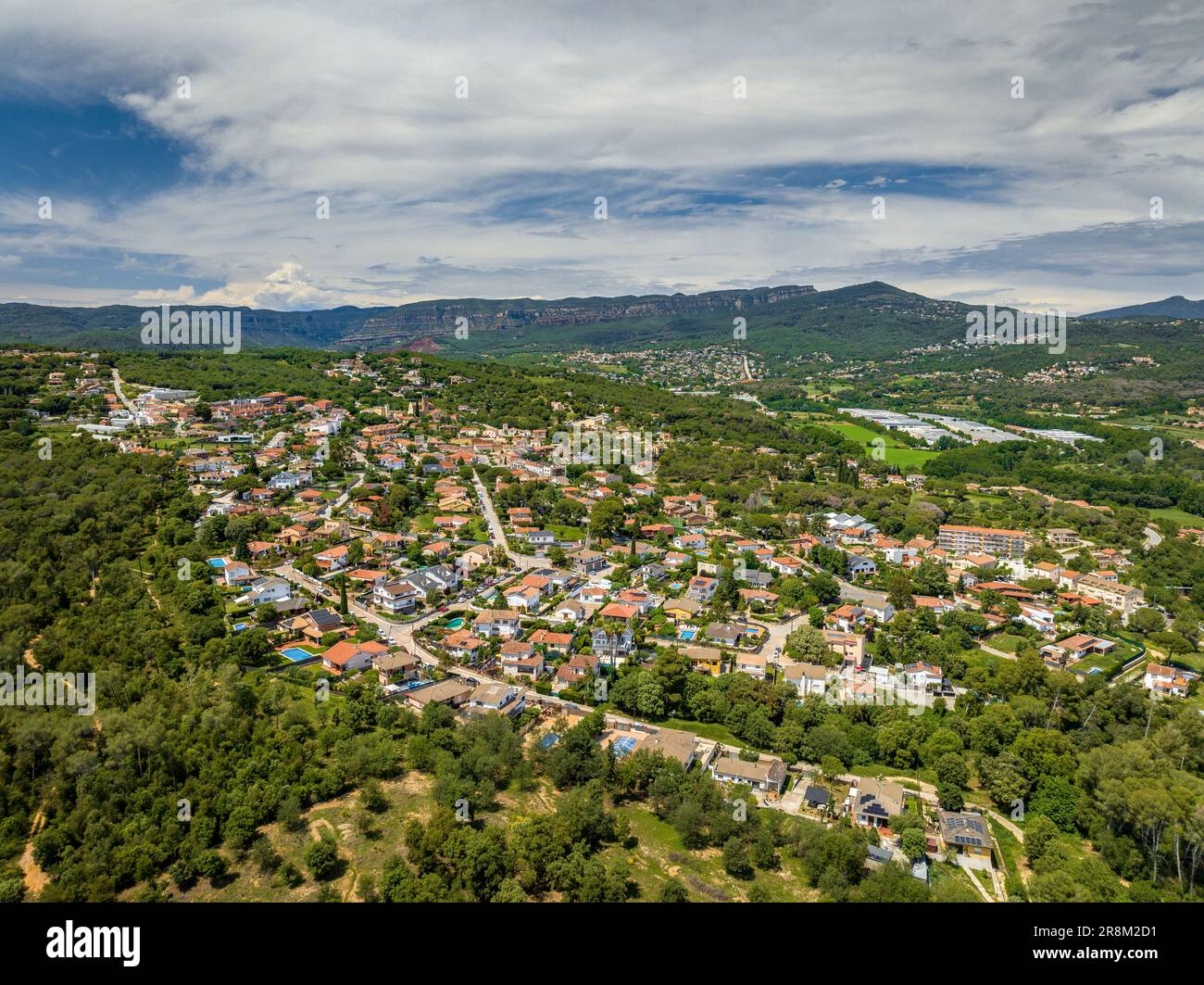 Aerial view of the town and residential areas of Santa Eulàlia de Ronçana with the green rural surroundings in spring. Vallès Oriental Barcelona Spain Stock Photo
