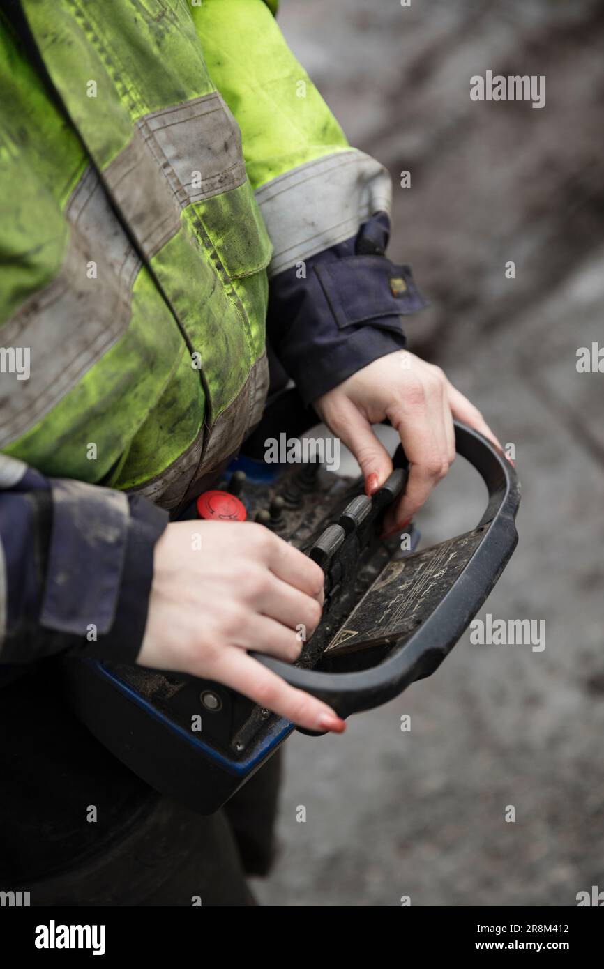Close-up of construction worker holding controller Stock Photo