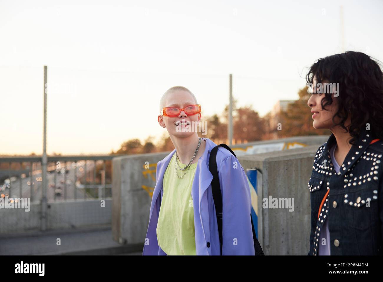 Smiling young women walking together and talking Stock Photo