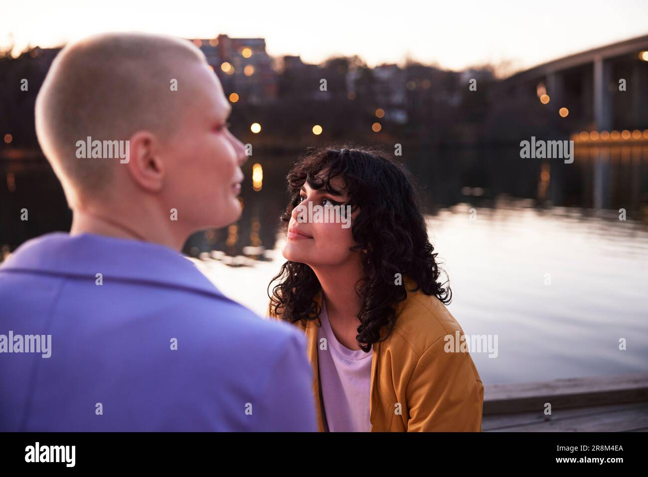 Young woman looking away, river in background Stock Photo