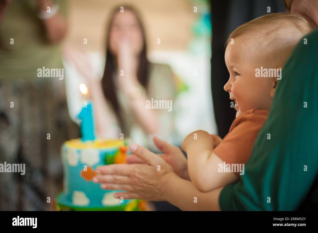 Cute baby boy celebrates his first birthday with his family at home