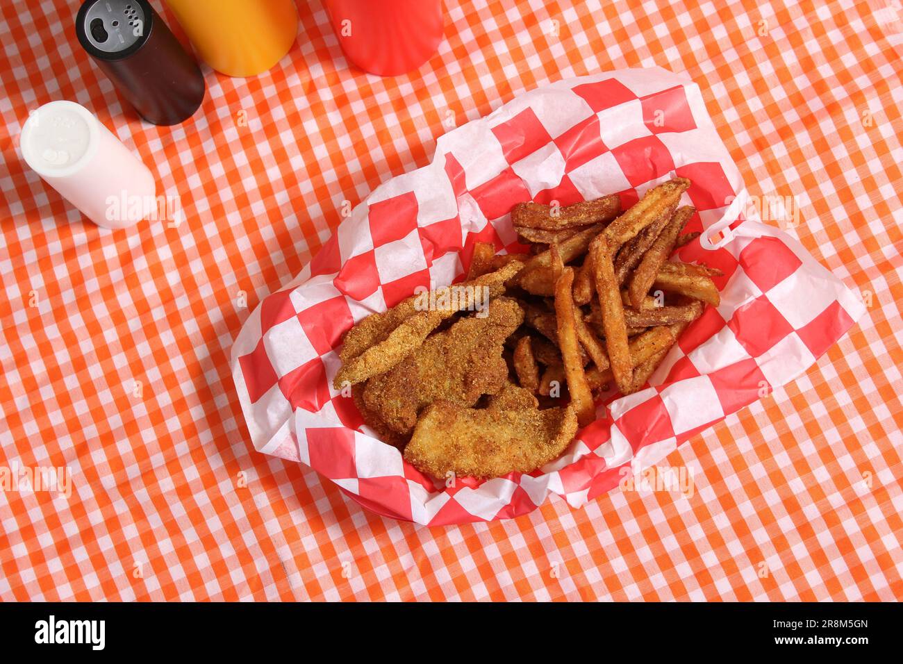 Fried Catfish Basket With French Fries in Rustic Cafe on Checkered