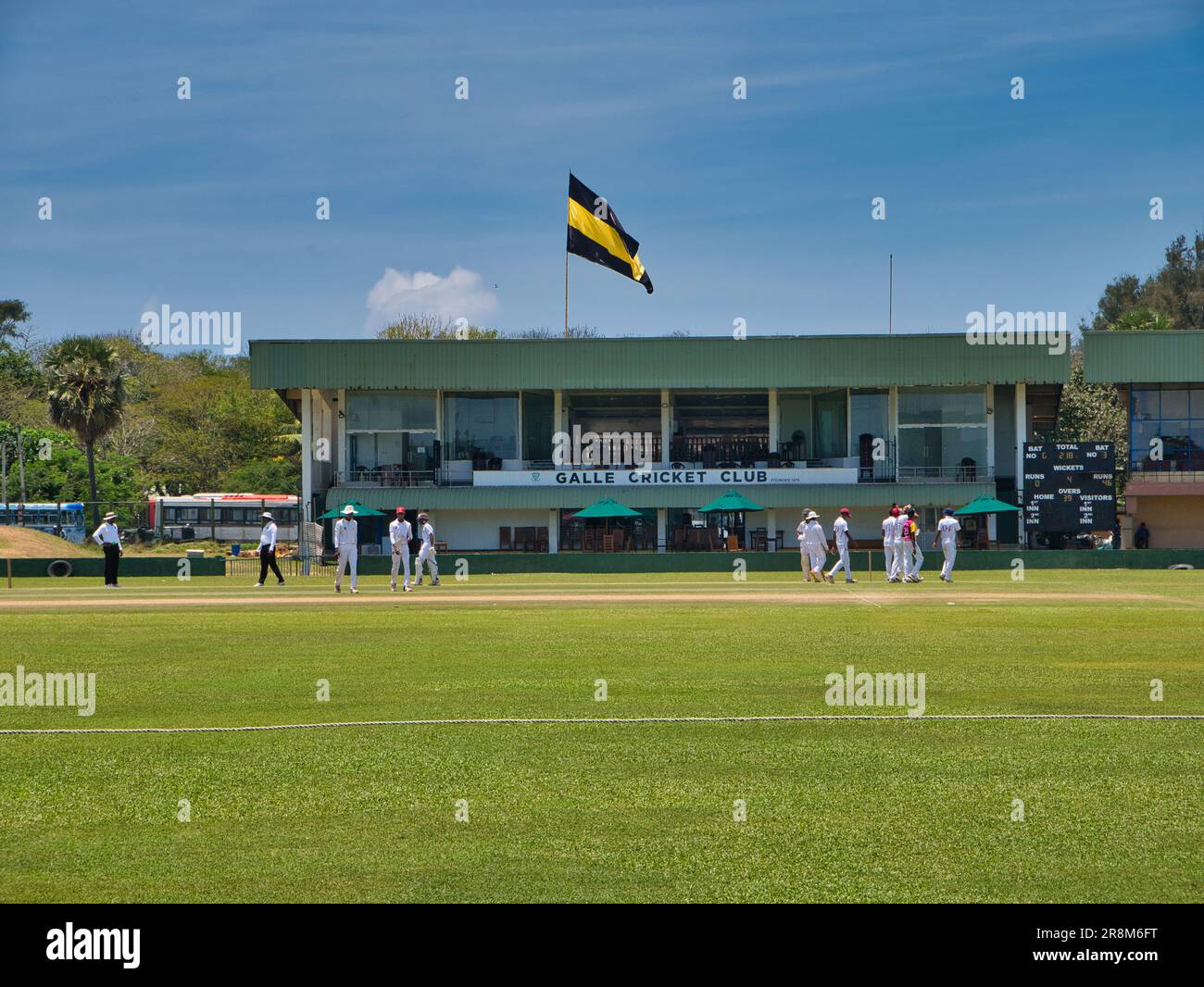Cricketers and buildings at Galle International Stadium in Galle in southern Sri Lanka. Taken on a sunny day. Stock Photo