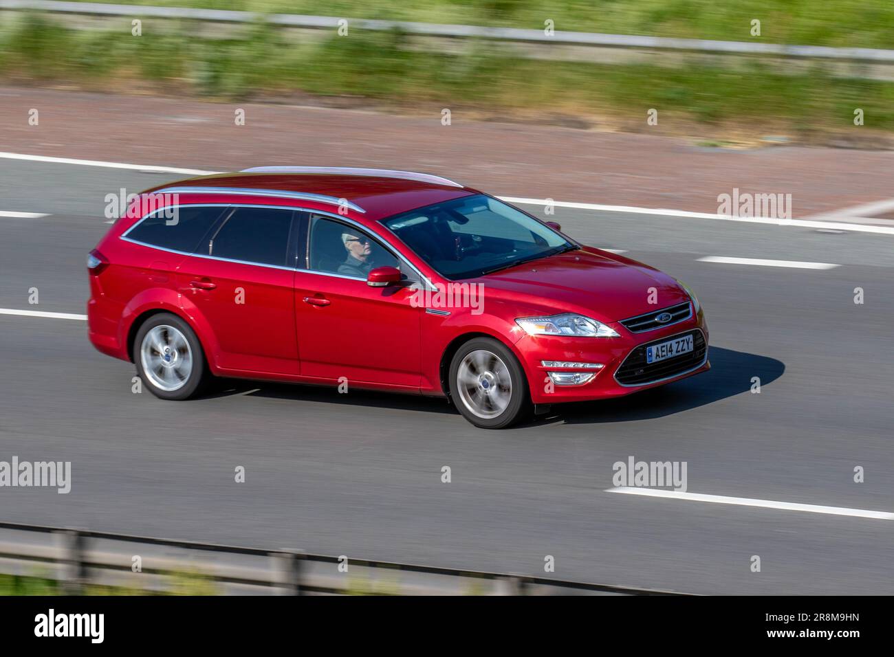 2014 Ford Mondeo Titanium X B-S EDN, Tdci 115 Econetic Start/Stop Red Estate Diesel 1560 cc travelling at speed on the M6 motorway in Greater Manchester, UK Stock Photo