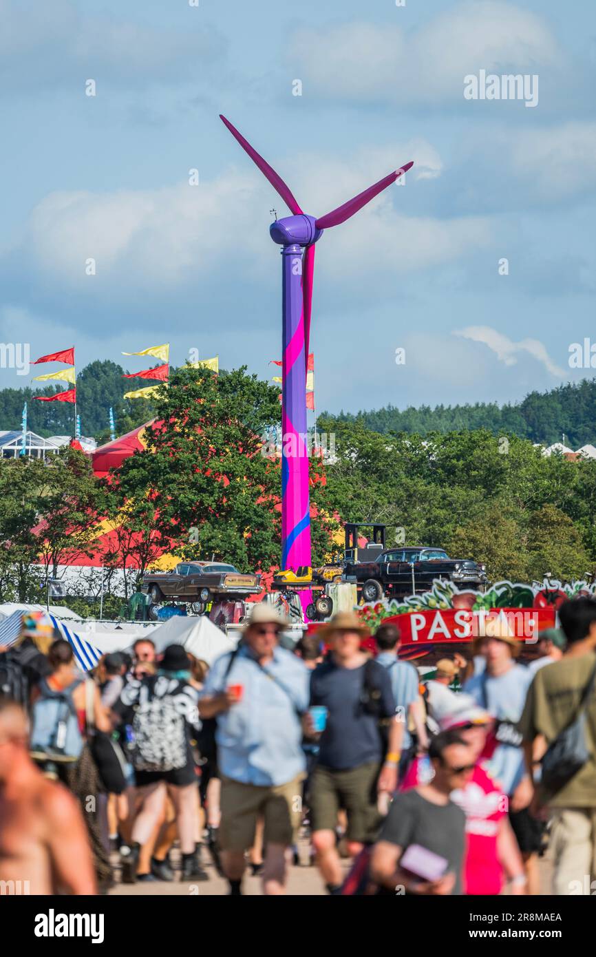 Glastonbury, UK. 21st June, 2023. Going green, a wind turbine provides power to the festival - The 2023 Glastonbury Festival, Worthy Farm, Glastonbury. Credit: Guy Bell/Alamy Live News Stock Photo