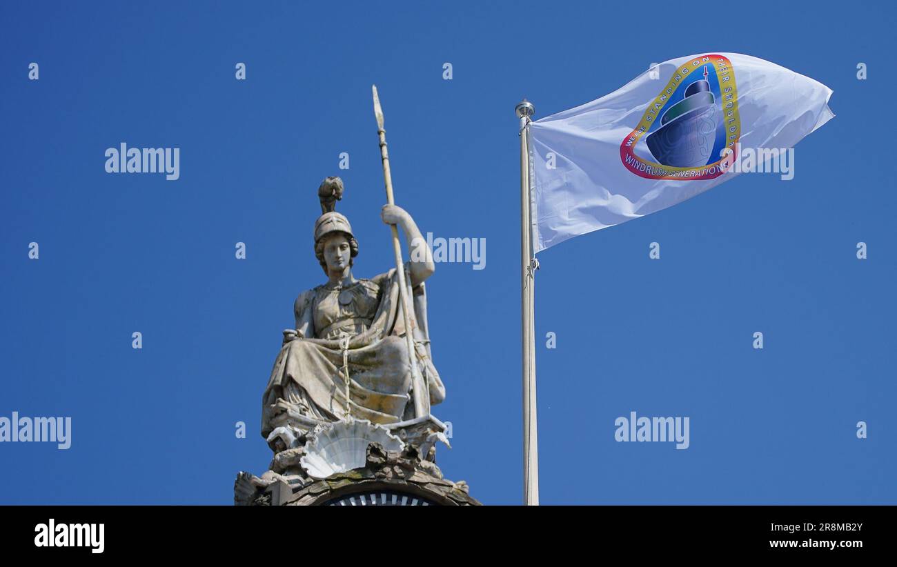 The Windrush flag flies over Liverpool Town Hall, marking the 75th anniversary of the arrival of the HMT Empire Windrush ship in Tilbury, Essex, carrying Caribbean families to the UK to help fill post-war labour shortages. Picture date: Thursday June 22, 2023. Stock Photo