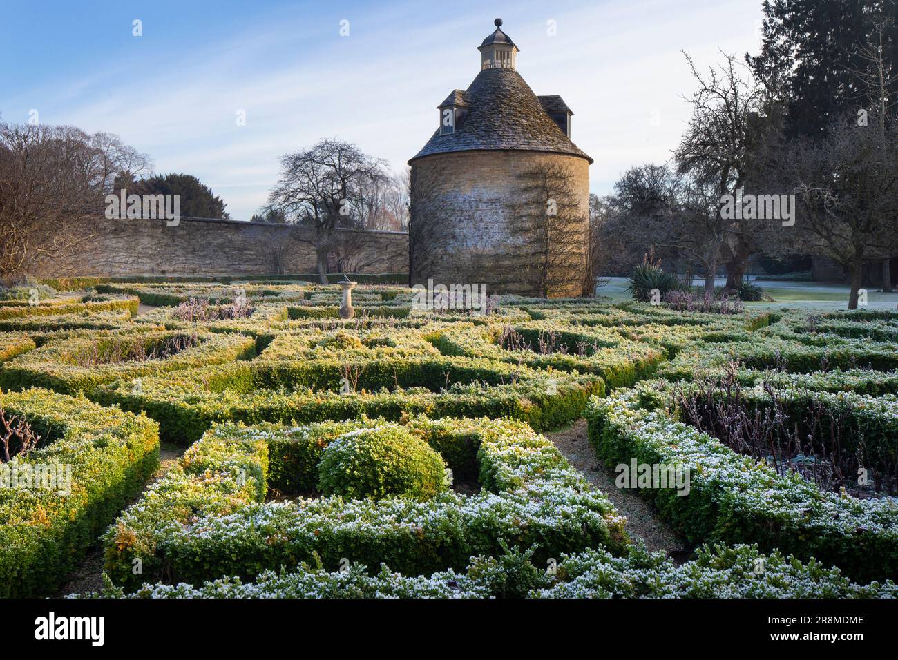 Rousham House and Gardens dovecot and box hedged topiary in winter frost, Oxfordshire,England Stock Photo