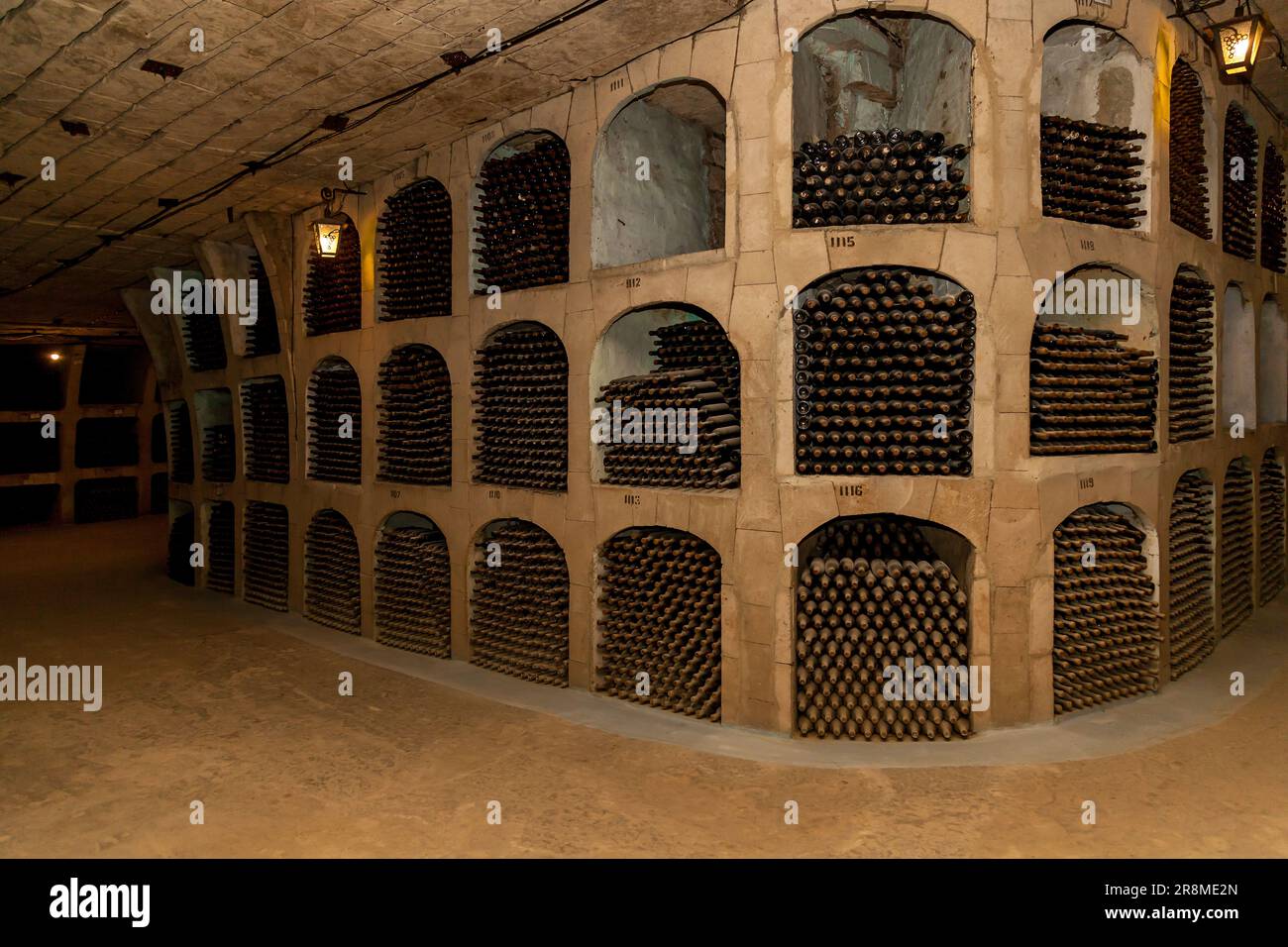 Old bottles of wine stacked in rows in the cellars of a winery Stock ...