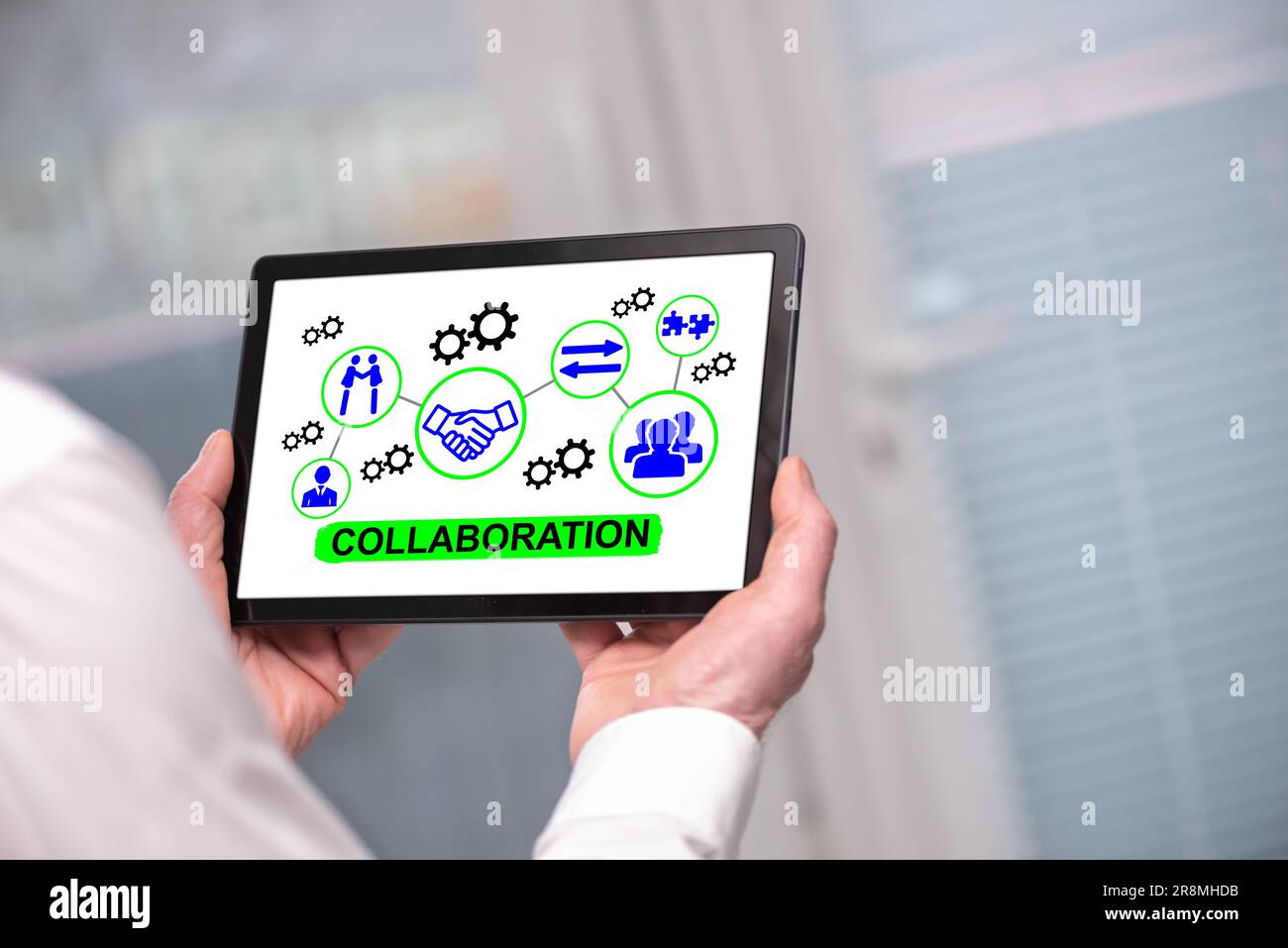Collaboration concept shown on a tablet held by a man Stock Photo
