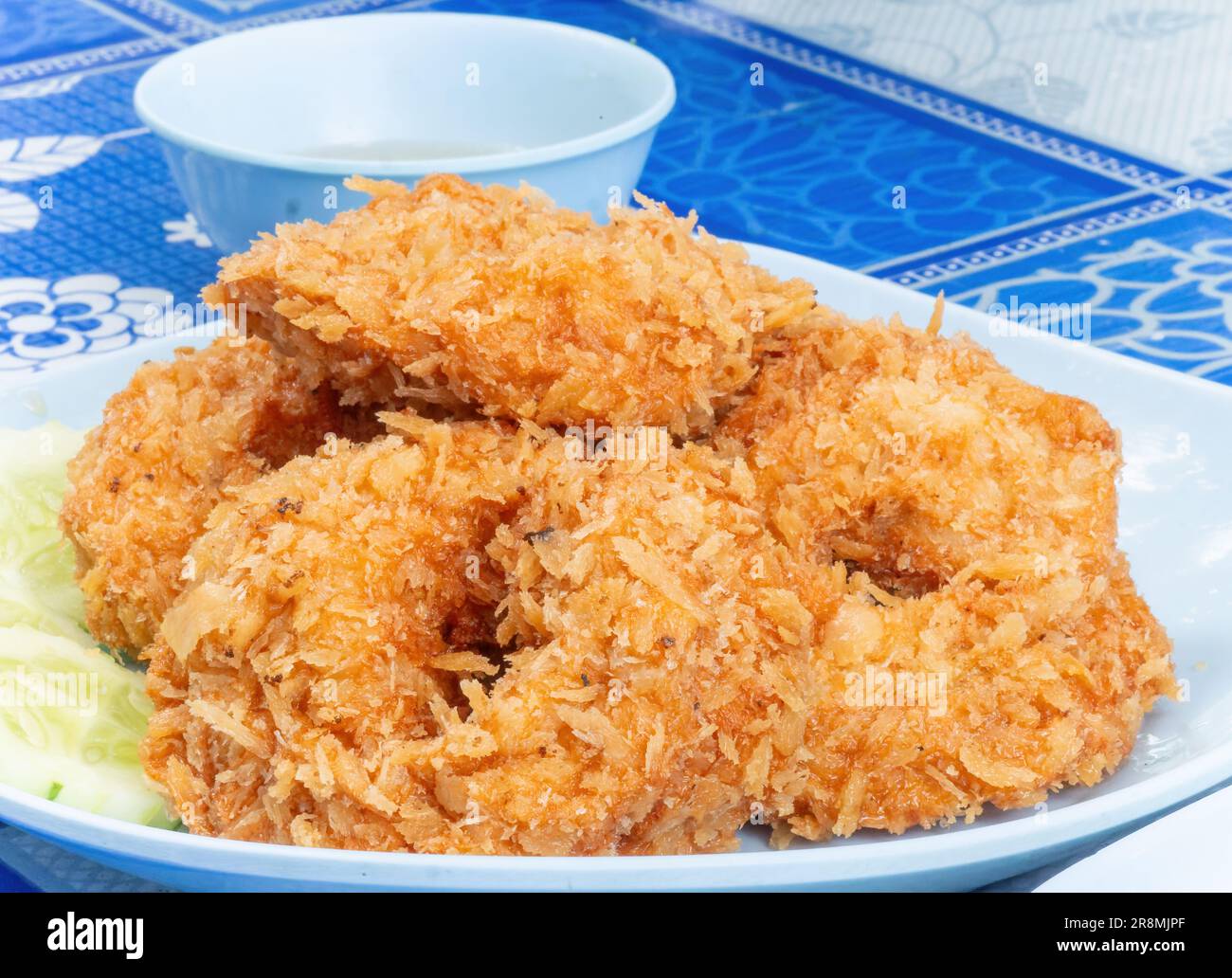 Tod man kung, Thai shrimp cakes, made from ground shrimp and other ingredients before rolling in flour, egg and bread crumbs and deep fried. Commonly Stock Photo
