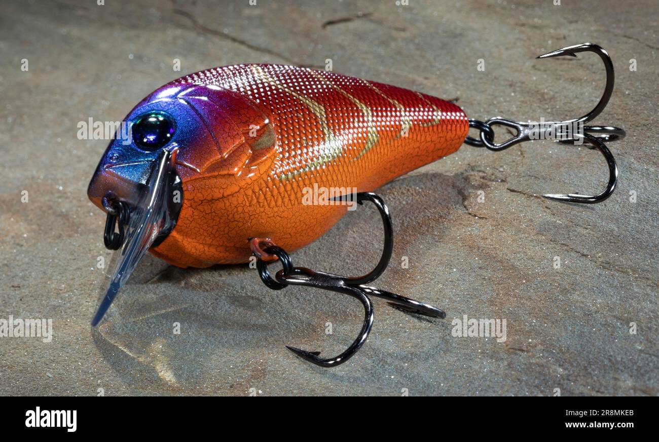 Bright orange fishing lure that is on a flat rock Stock Photo - Alamy