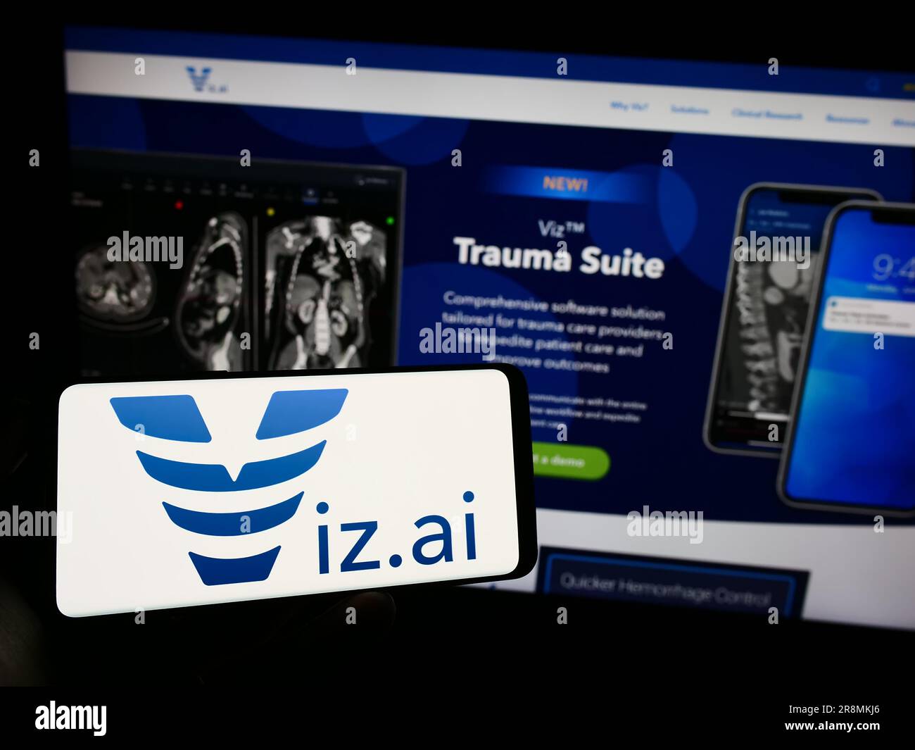 Person holding cellphone with logo of American artificial intelligence company Viz.ai Inc. on screen in front of webpage. Focus on phone display. Stock Photo