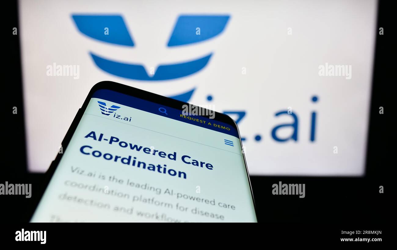 Mobile phone with website of US artificial intelligence company Viz.ai Inc. on screen in front of logo. Focus on top-left of phone display. Stock Photo
