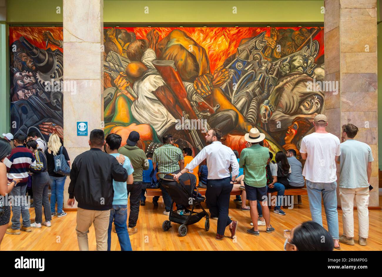 People viewing 'Katharsis' 1934 mural by Jose Clemente Orozco, Palacio