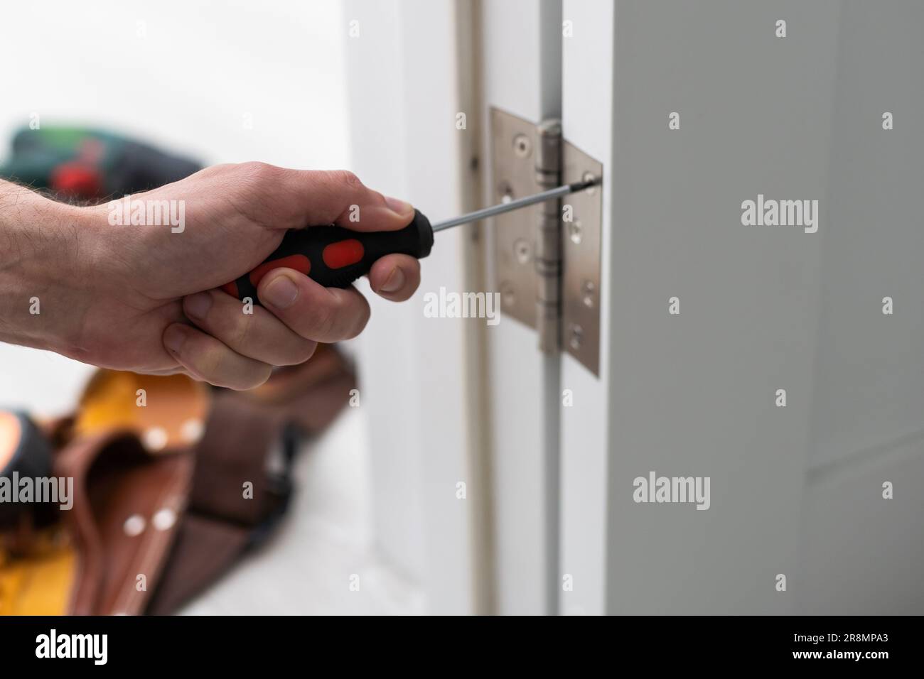 Locksmith install the door lock in house Stock Photo Alamy