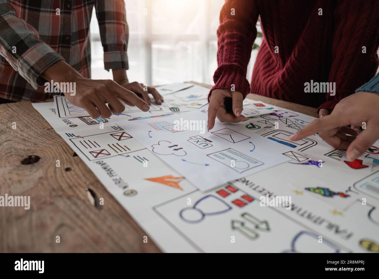 Creative designer choosing color samples for mobile responsive website development with UI UX. Developing wireframe sketch layout design mockup on Stock Photo