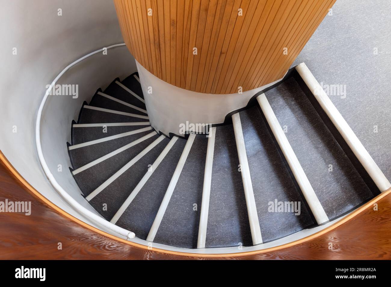 Spiral staircase goes down, top view, abstract architecture photo background Stock Photo