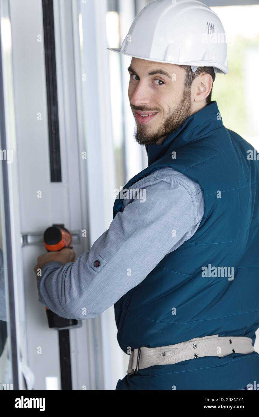 builder drills a door Stock Photo Alamy