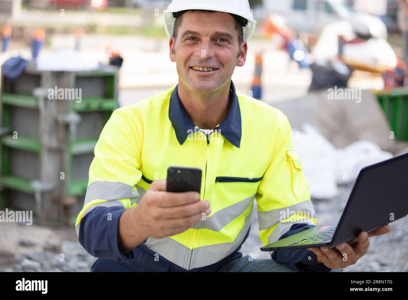 builder manager using laptop and mobile phone Stock Photo