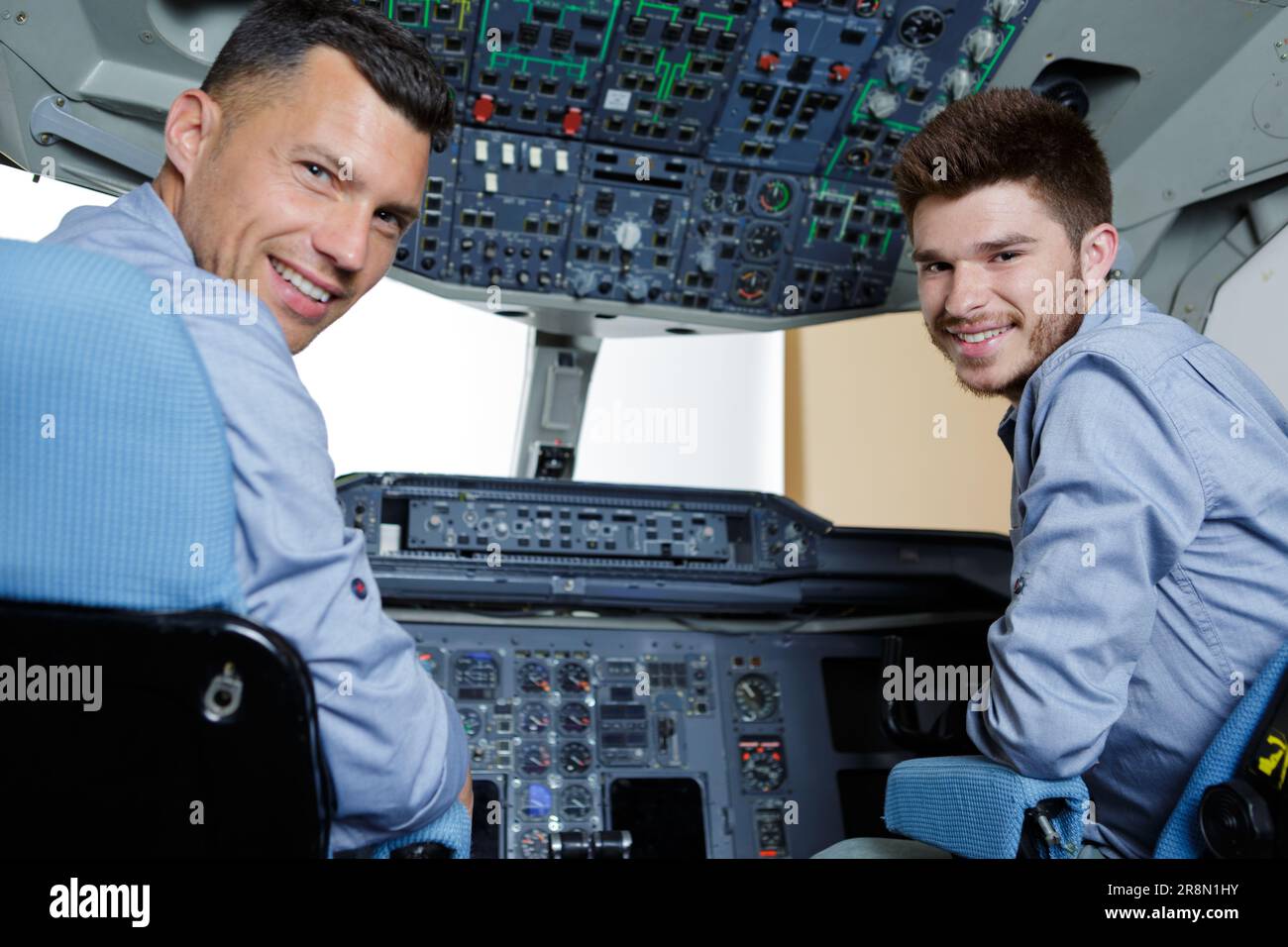 apprentice on flight simulator cockpit Stock Photo