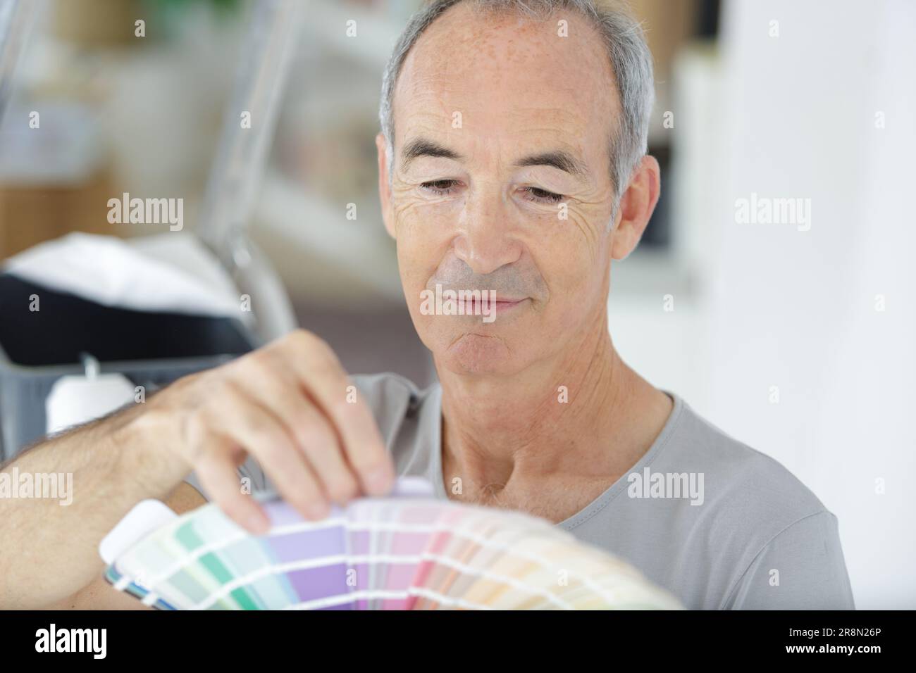 elderly man holding a color swatch Stock Photo