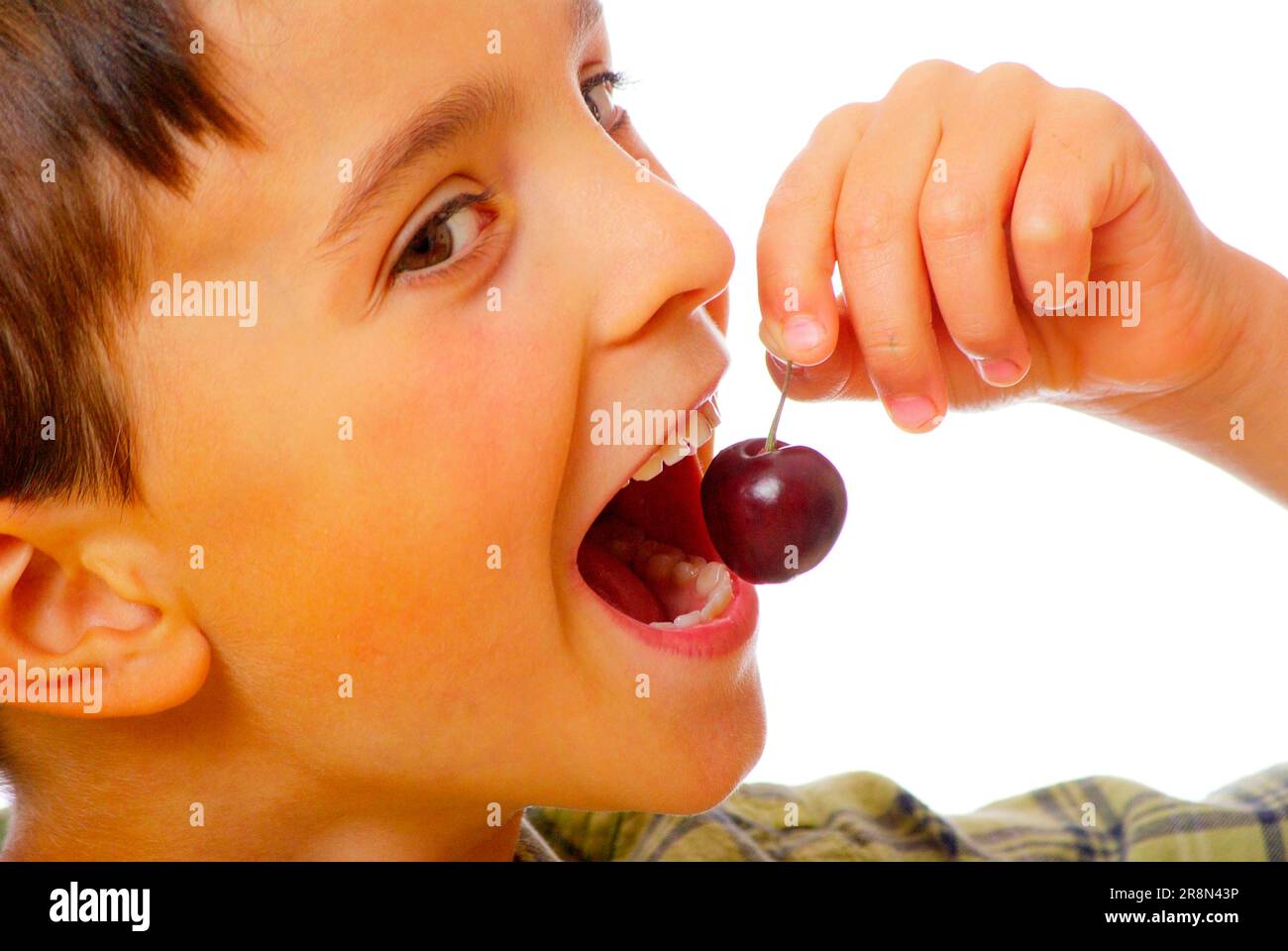 Boy with cherry Stock Photo