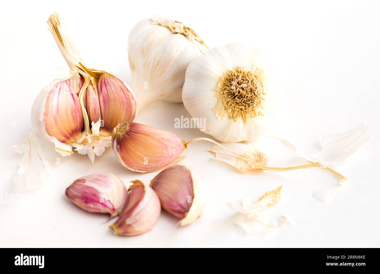 garlic heads and cloves on white background Stock Photo - Alamy