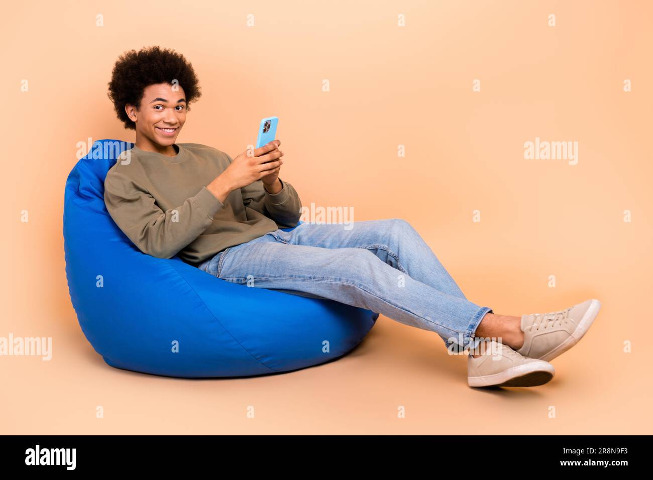 Full body photo of youngster chilling guy browsing instagram reels
