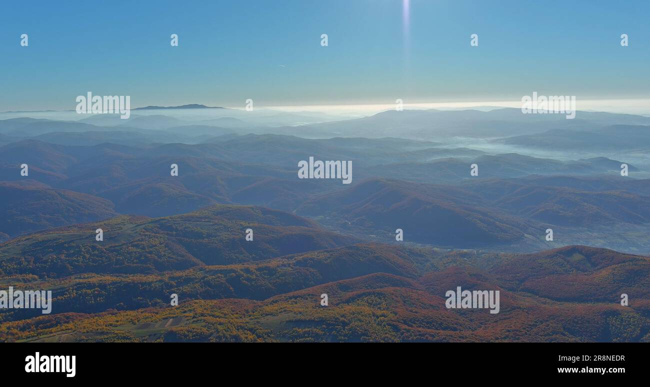 Early morning in Carpathian valley of mountain forest with foggy autumn ...