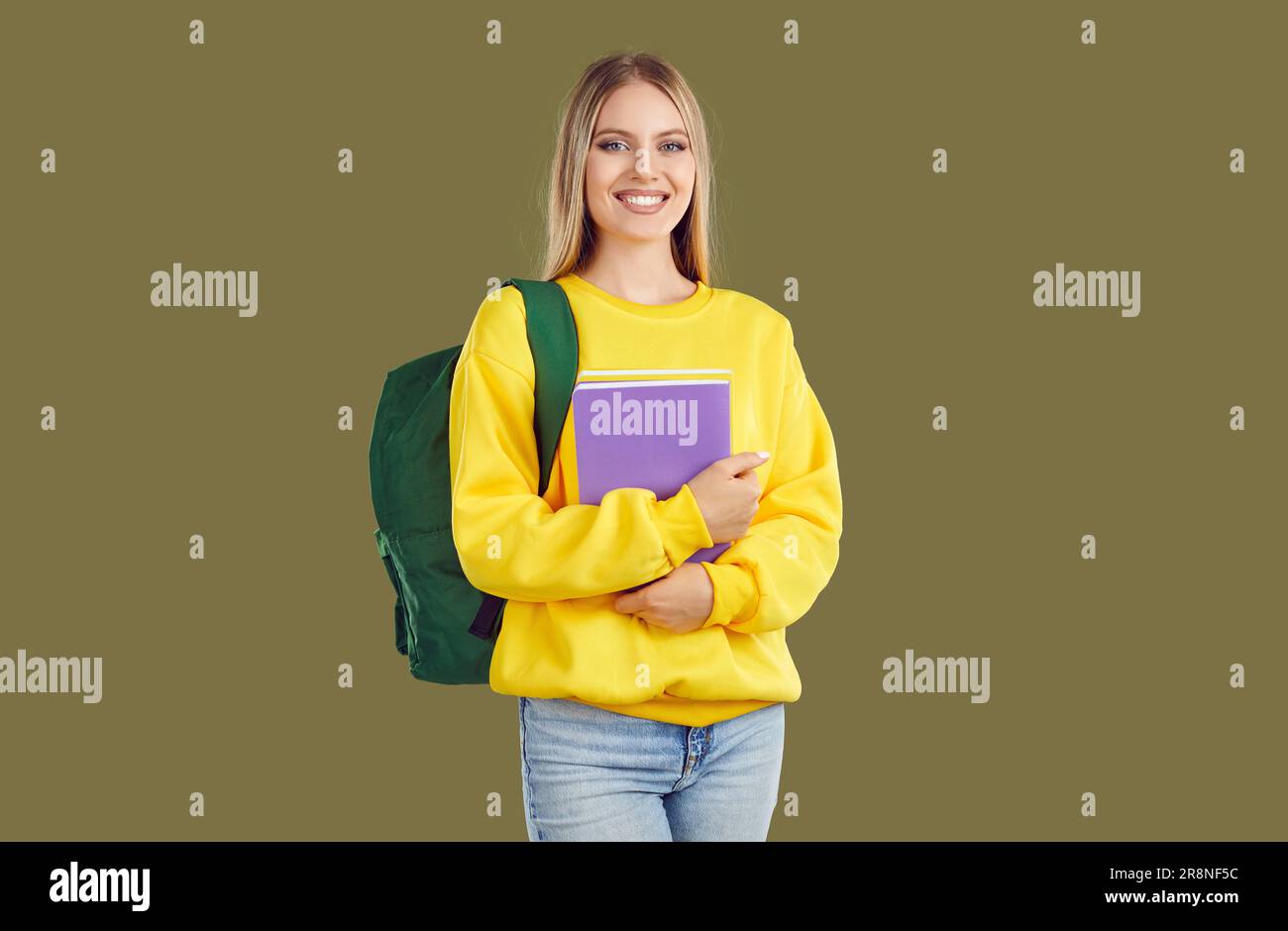 Beautiful young student with a backpack and textbooks. Stock Photo