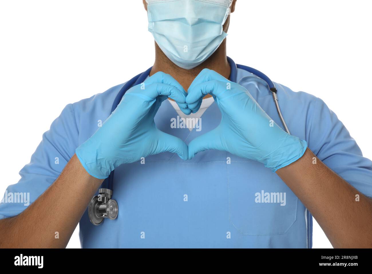 Doctor or medical assistant (male nurse) making heart with hands on ...